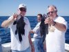 9-4 - Wayne and Jim show off a couple of sea bass to 18 in. while Paul enjoys his stogie in the background.